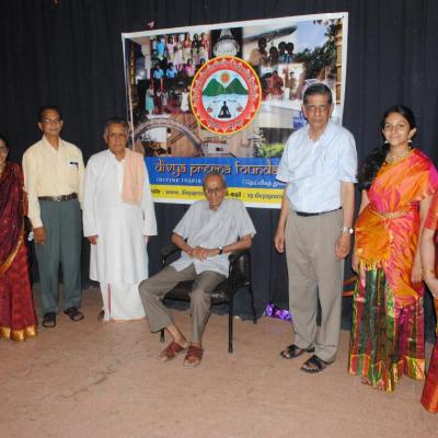 Trustees Families In Front Of Divya Prerna Banner