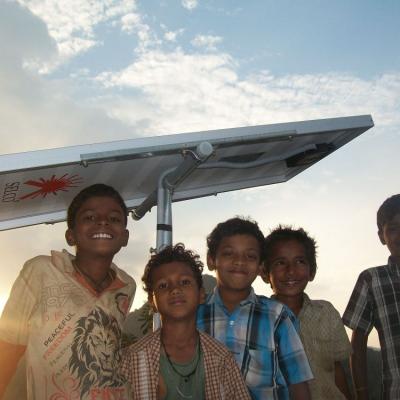 Bearing Tribal Children Below The Solar Panel